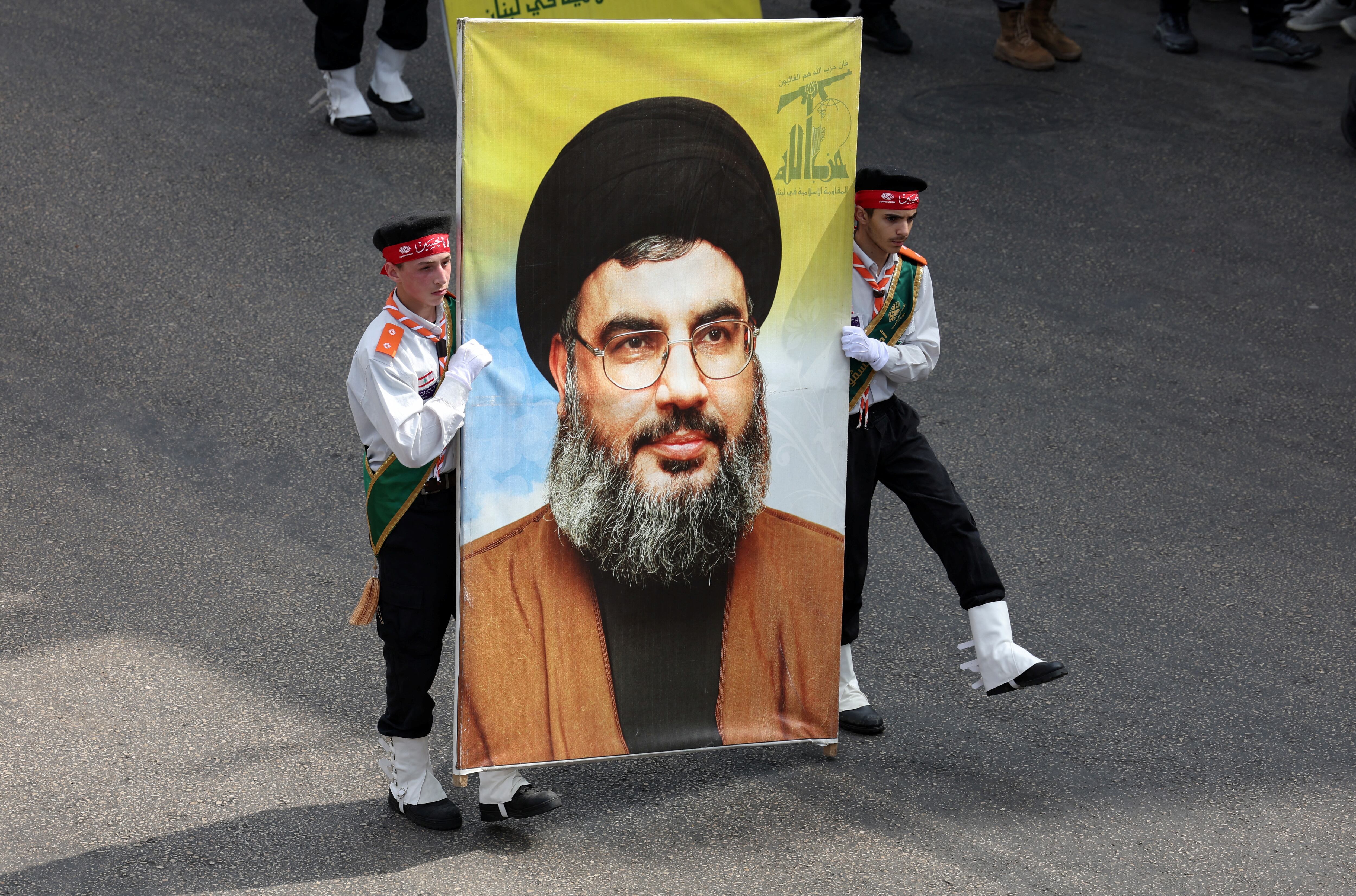 Miembros de los scouts Imam al-Mahdi llevan una imagen del líder del Hezbolá libanés Hassan Nasrallah, durante una procesión religiosa para conmemorar la Ashura en los suburbios de Beirut, Líbano, el 17 de julio de 2024, un día antes de cumplirse los 30 años del atentado a AMIA (REUTERS/Aziz Taher)