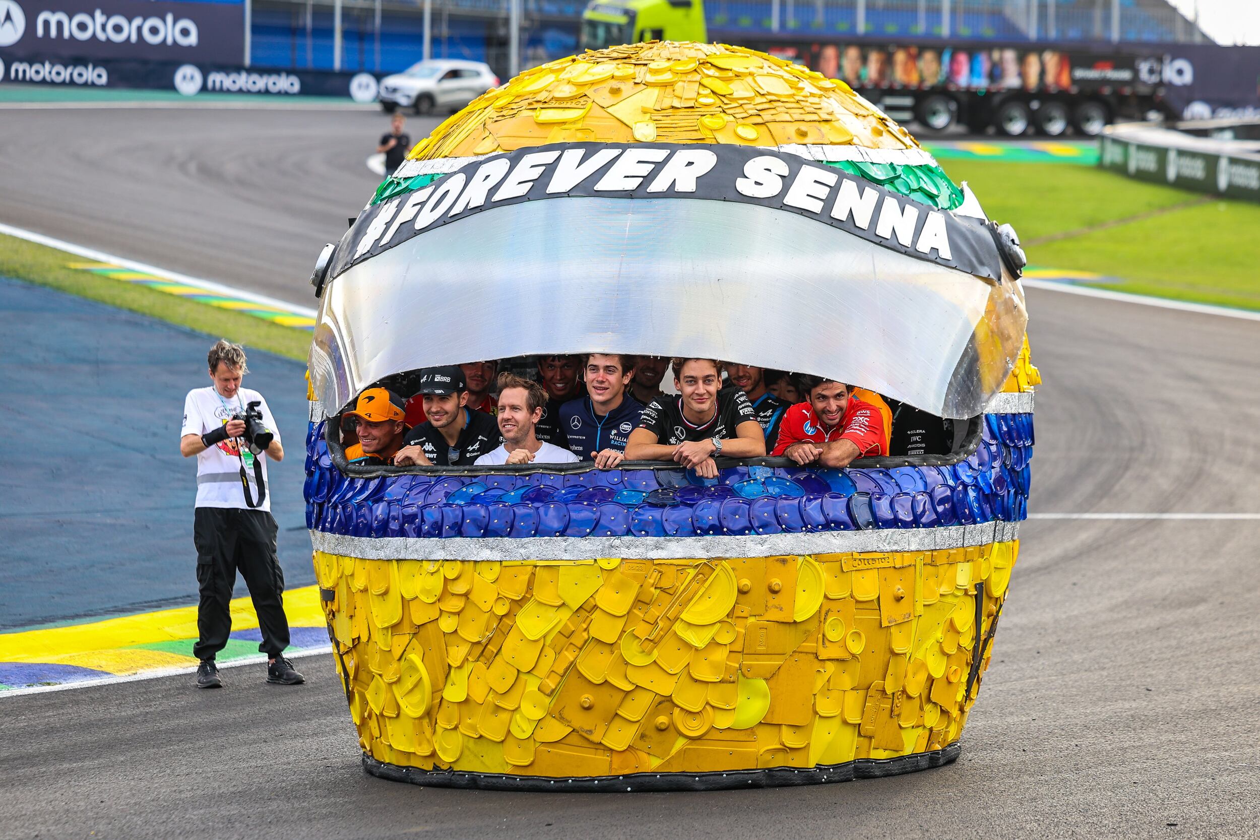 Franco Colapinto y otro pilotos de F1 en Brasil. Casco homenaje a Ayrton senna hecho con materiales reciclados As well as honouring the legacy of Ayrton Senna, Sebastian Vettel's latest sustainability campaign showcases the importance of keeping our world clean 